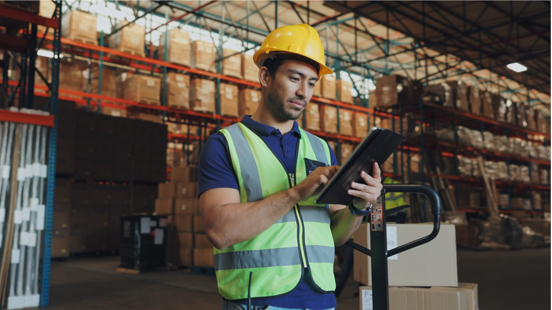 Warehouse worker using a tablet to monitor AI-powered supply chain